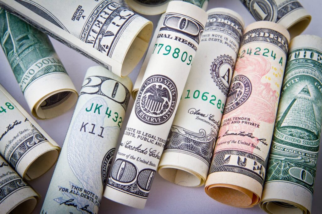 pexels-photo-164527 Close-up of rolled US dollar bills symbolizing wealth, financial success, and currency.